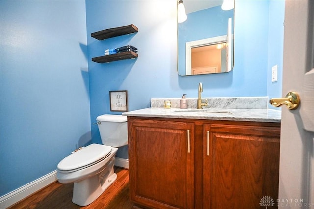 bathroom featuring hardwood / wood-style flooring, vanity, and toilet