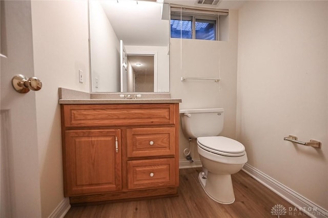 bathroom featuring hardwood / wood-style flooring, vanity, and toilet