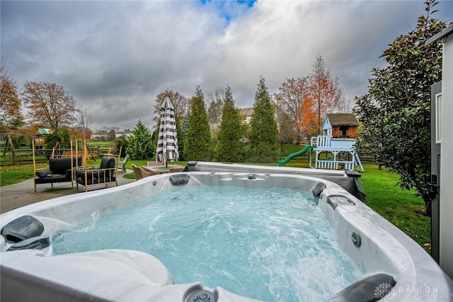 view of pool featuring a hot tub and a playground