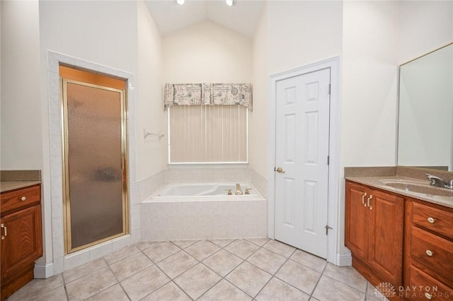 bathroom with vanity, vaulted ceiling, tile patterned floors, and separate shower and tub