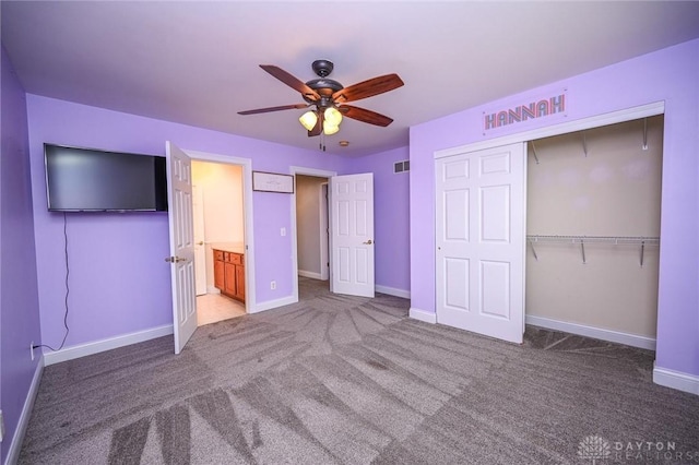 unfurnished bedroom with a closet, ceiling fan, and carpet flooring