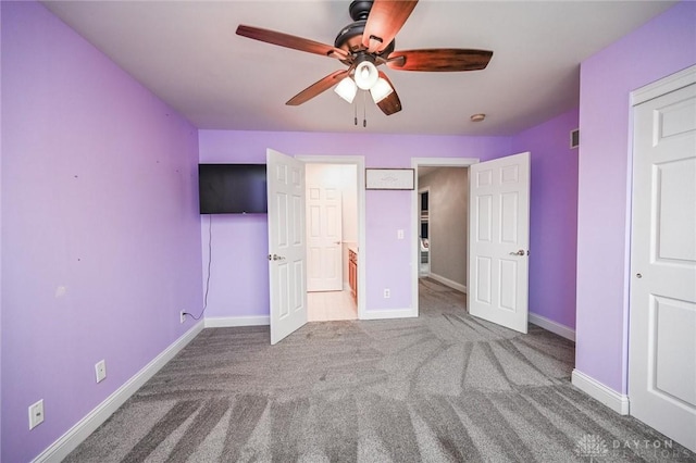 unfurnished bedroom with carpet floors and ceiling fan