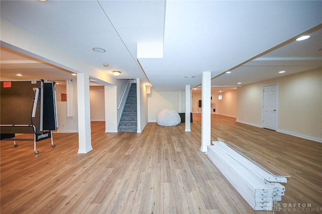 basement with light hardwood / wood-style flooring