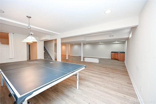 game room with light wood-type flooring