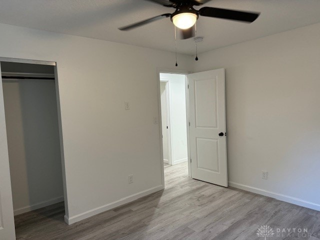 unfurnished bedroom featuring light wood-type flooring, a closet, and ceiling fan