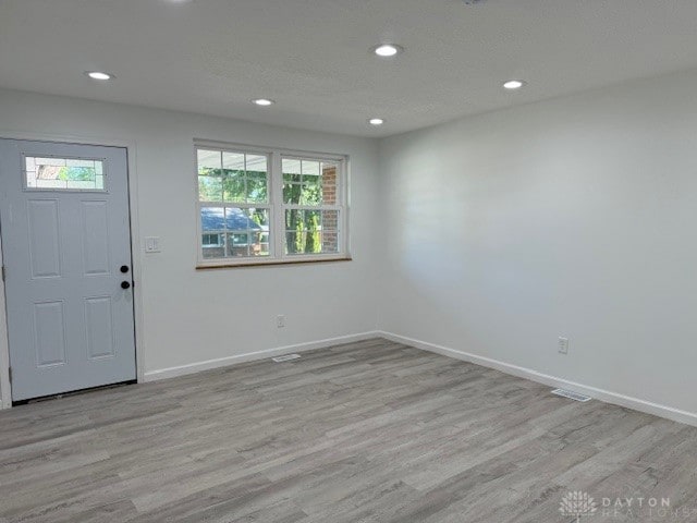 entrance foyer featuring light hardwood / wood-style floors and a wealth of natural light