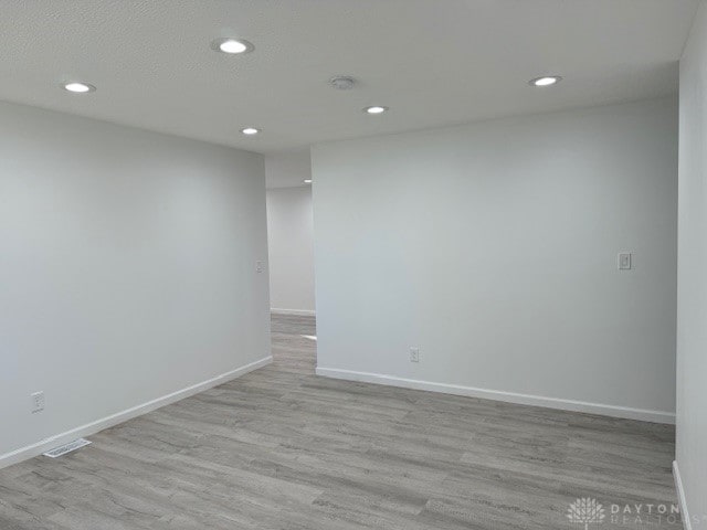 spare room featuring light wood-type flooring