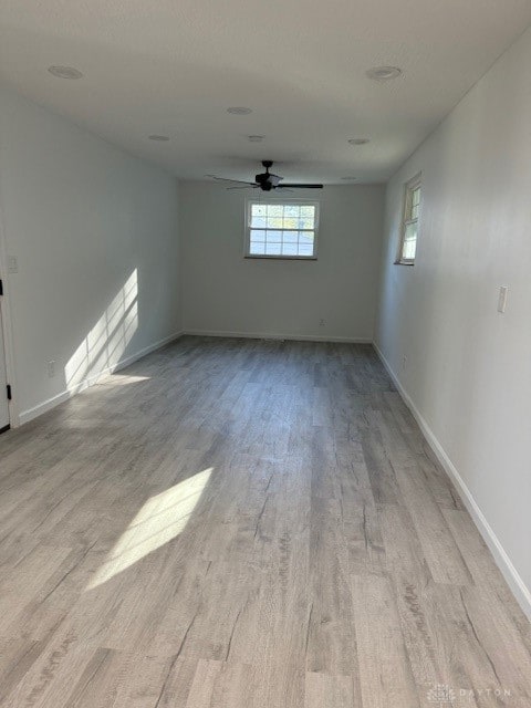 unfurnished room with ceiling fan and light hardwood / wood-style flooring