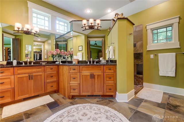 bathroom featuring walk in shower, vanity, and an inviting chandelier