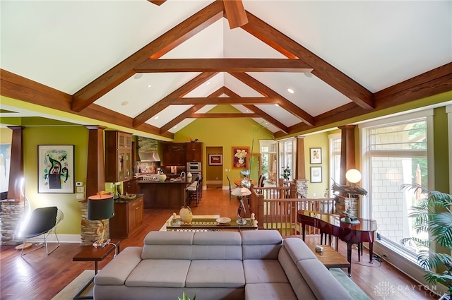 living room featuring vaulted ceiling with beams and wood-type flooring