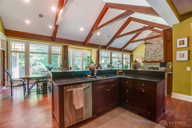 kitchen featuring a wealth of natural light, dishwasher, a center island with sink, and sink