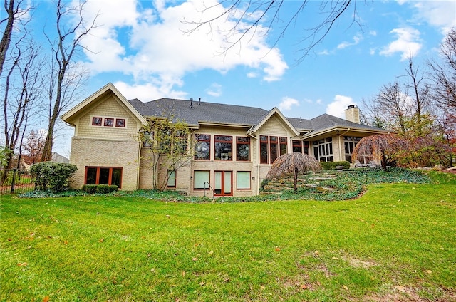 rear view of house featuring a lawn