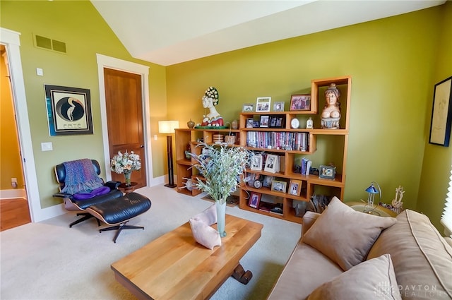 sitting room with carpet flooring and lofted ceiling