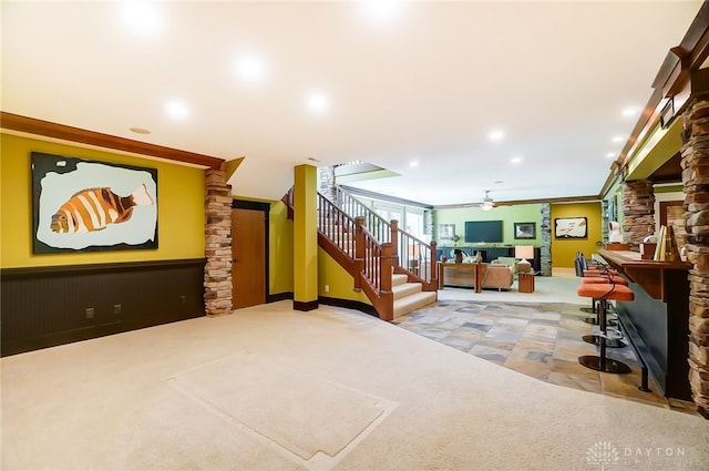 interior space with ceiling fan, carpet floors, and crown molding