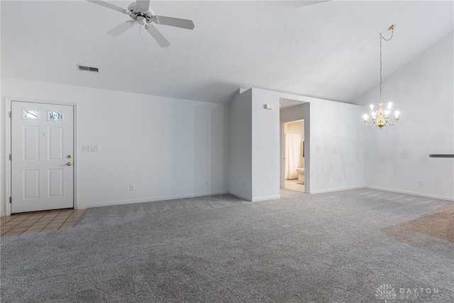 unfurnished living room featuring light carpet, ceiling fan with notable chandelier, and vaulted ceiling