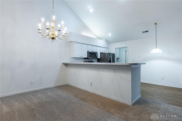 kitchen featuring kitchen peninsula, white cabinetry, stainless steel appliances, and hanging light fixtures