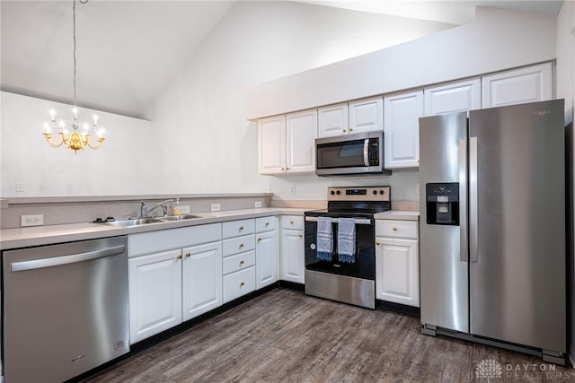 kitchen featuring white cabinets, pendant lighting, high vaulted ceiling, and stainless steel appliances