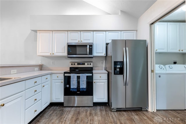 kitchen with white cabinets, dark hardwood / wood-style floors, independent washer and dryer, and stainless steel appliances