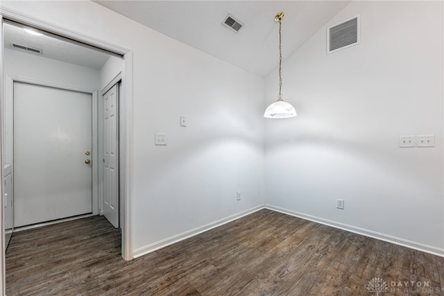 spare room with dark hardwood / wood-style floors and lofted ceiling