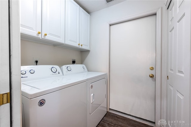 washroom with cabinets, a textured ceiling, dark wood-type flooring, and washing machine and clothes dryer