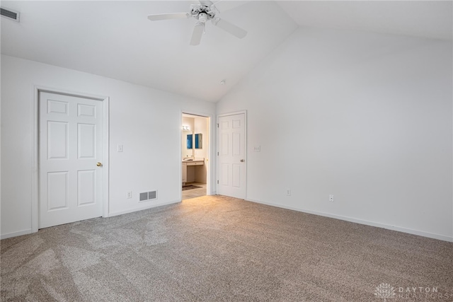 unfurnished bedroom with ensuite bathroom, ceiling fan, light colored carpet, and high vaulted ceiling