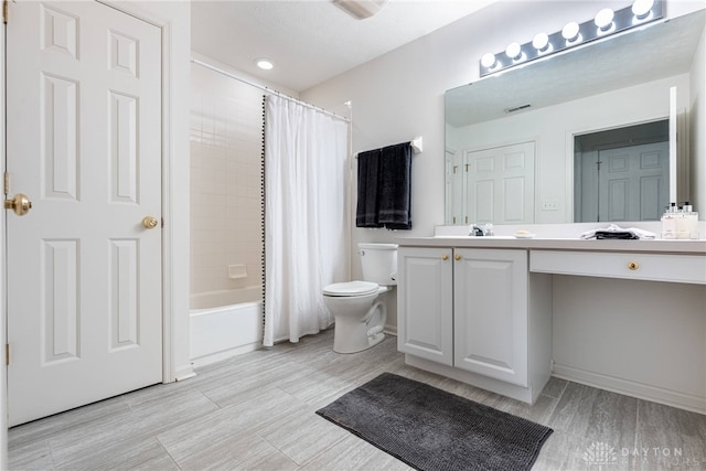 full bathroom with vanity, toilet, and shower / bath combo