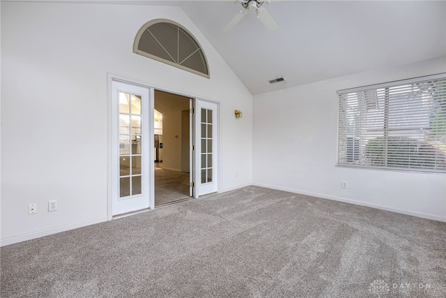 spare room featuring french doors, carpet floors, high vaulted ceiling, and ceiling fan