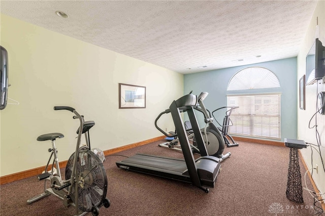 workout room with carpet and a textured ceiling