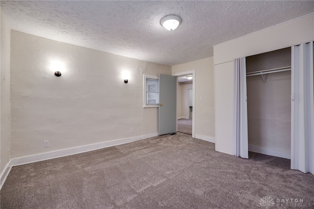 unfurnished bedroom with carpet flooring, a closet, and a textured ceiling