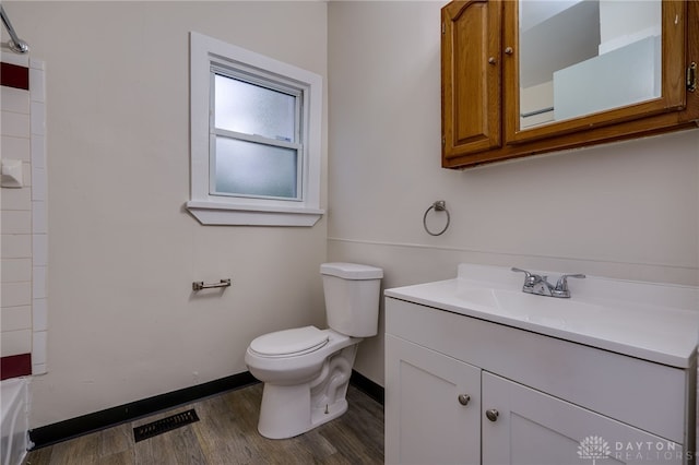 bathroom with toilet, vanity, and hardwood / wood-style flooring