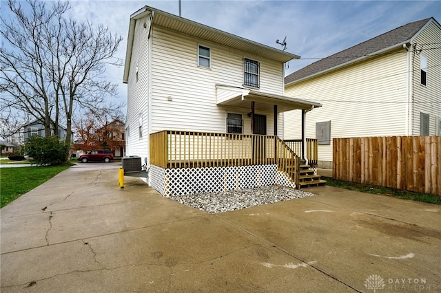 rear view of house featuring cooling unit