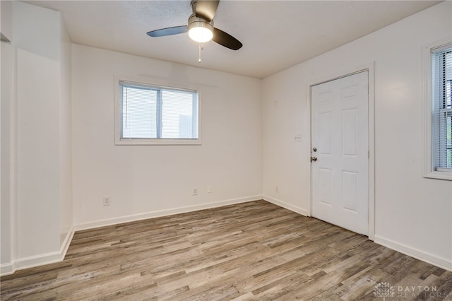 empty room featuring ceiling fan and hardwood / wood-style floors