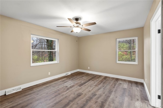 unfurnished room with hardwood / wood-style flooring and ceiling fan