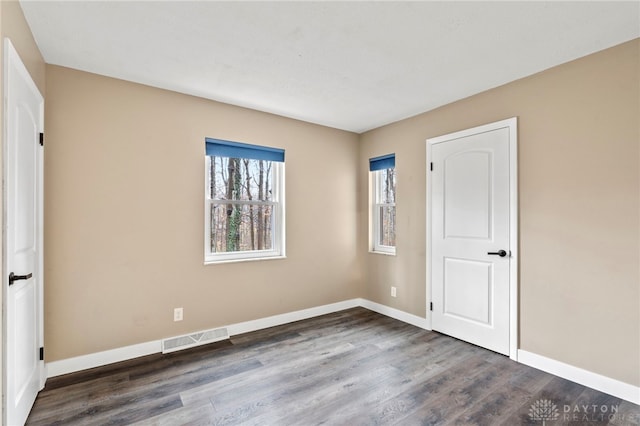 empty room featuring dark hardwood / wood-style floors