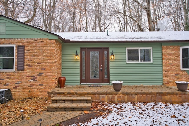 view of snow covered property entrance