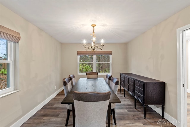 dining room featuring a notable chandelier and dark wood-type flooring