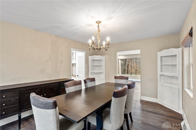 dining area featuring dark hardwood / wood-style floors and an inviting chandelier