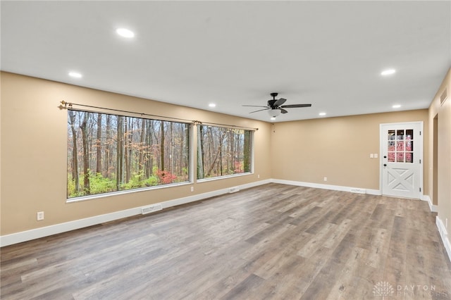 unfurnished living room with ceiling fan and light hardwood / wood-style flooring