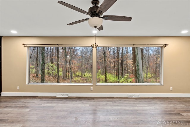 spare room with ceiling fan and wood-type flooring