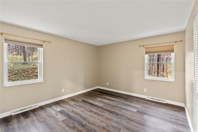 spare room with dark wood-type flooring