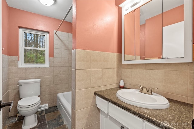 full bathroom with tile walls, vanity,  shower combination, and toilet