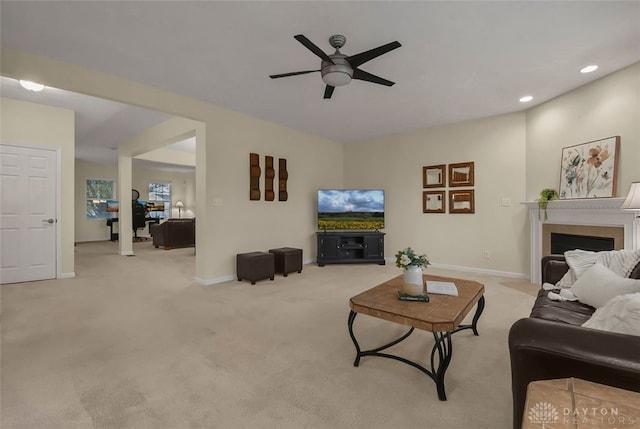 carpeted living room featuring ceiling fan