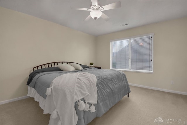 bedroom with light colored carpet and ceiling fan