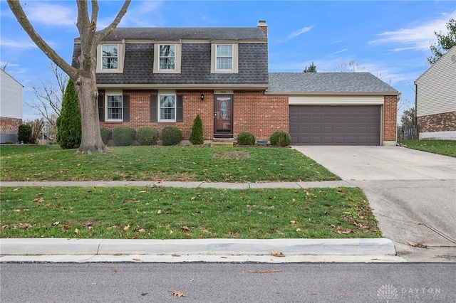 view of front of house featuring a front yard and a garage