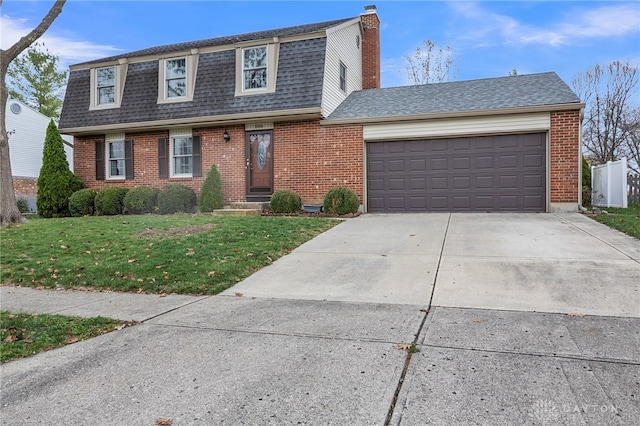 view of front of house with a front lawn and a garage