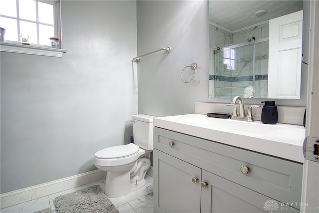 bathroom featuring vanity, a shower with shower door, and toilet