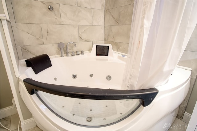 bathroom featuring a bathtub and tile walls