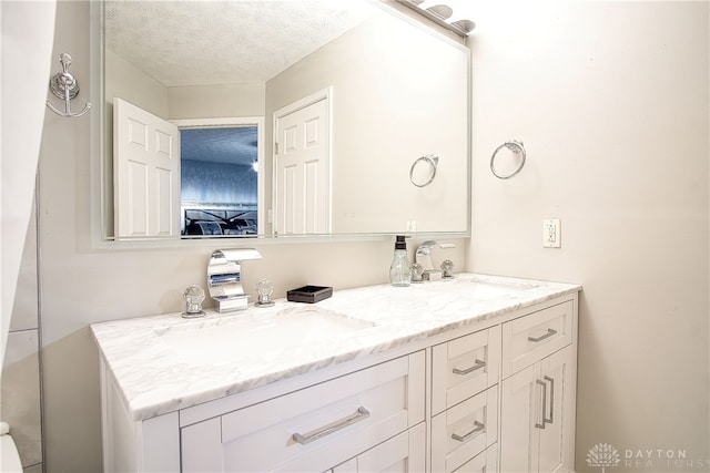 bathroom with vanity and a textured ceiling