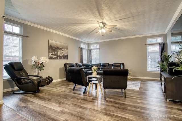 living room featuring hardwood / wood-style floors, a wealth of natural light, and ornamental molding