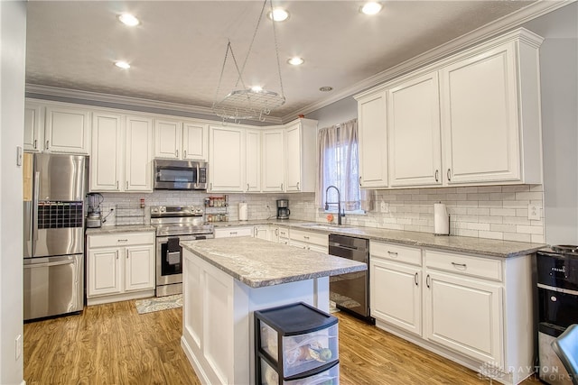 kitchen with crown molding, sink, a center island, and stainless steel appliances